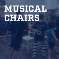 a young boys playing musical chairs